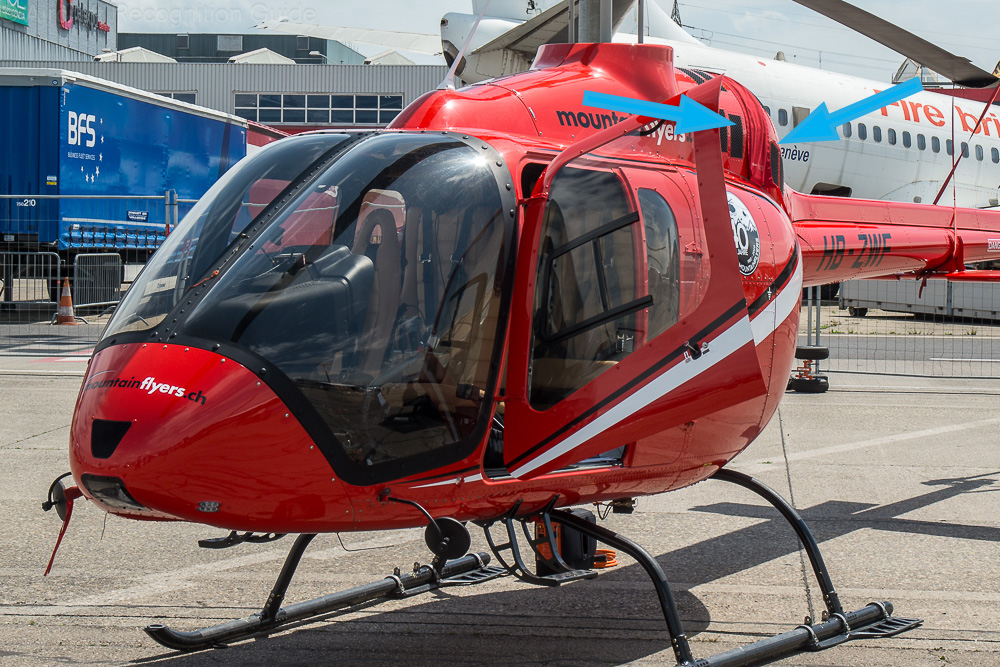 The Jet Ranger X has its own distinctive cockpit and cabin window pattern, with the front windows curving down the side of the fuselage. Also note the typical cooling intakes marked by the arrows. Image